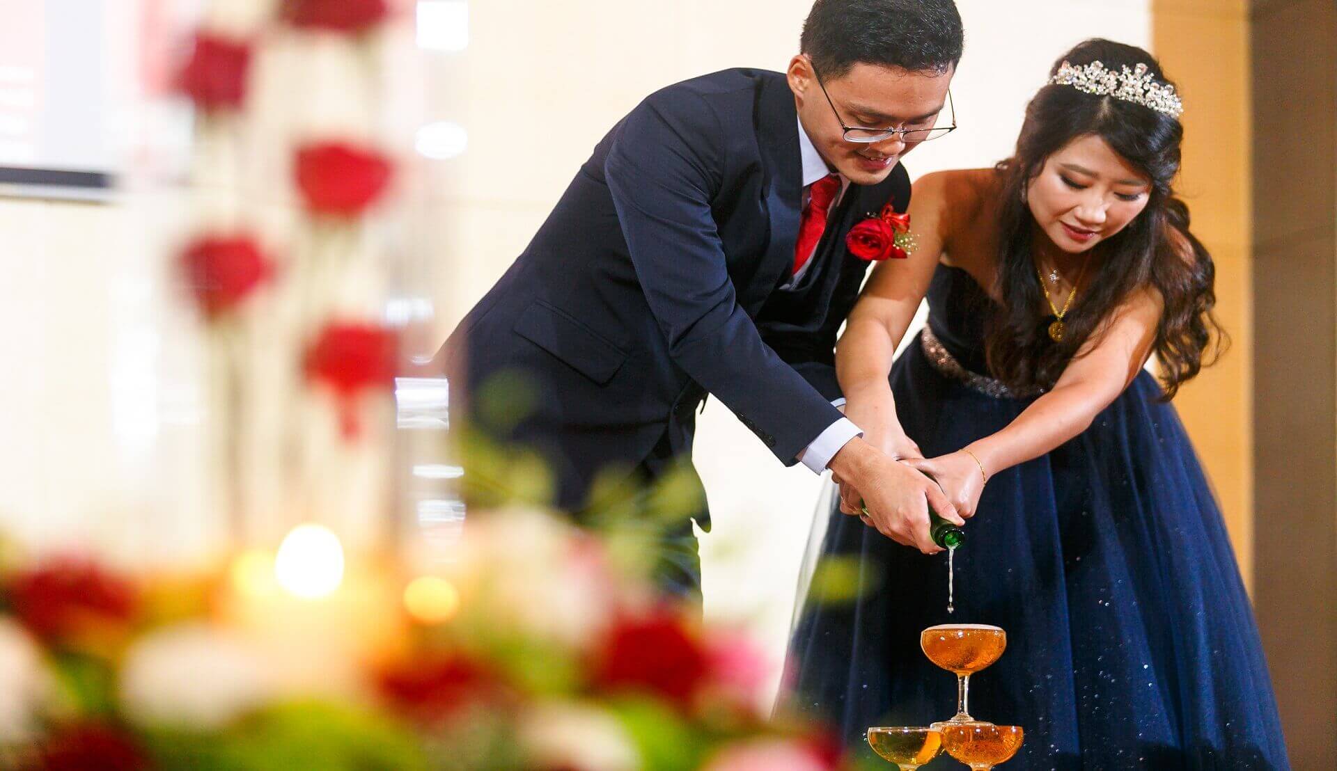Sugar & Spice Events -Newlywed couple champagne pouring in glasses