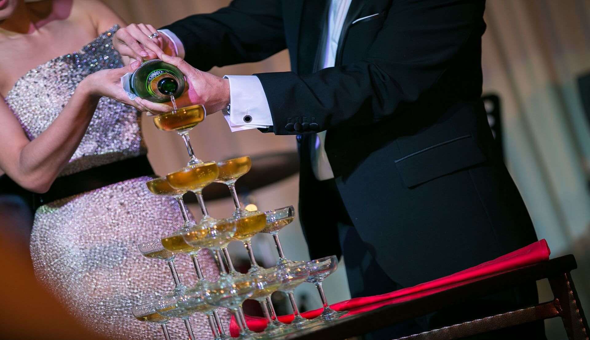 Sugar & Spice Events - Newly wed couple pouring champagne in the wedding reception