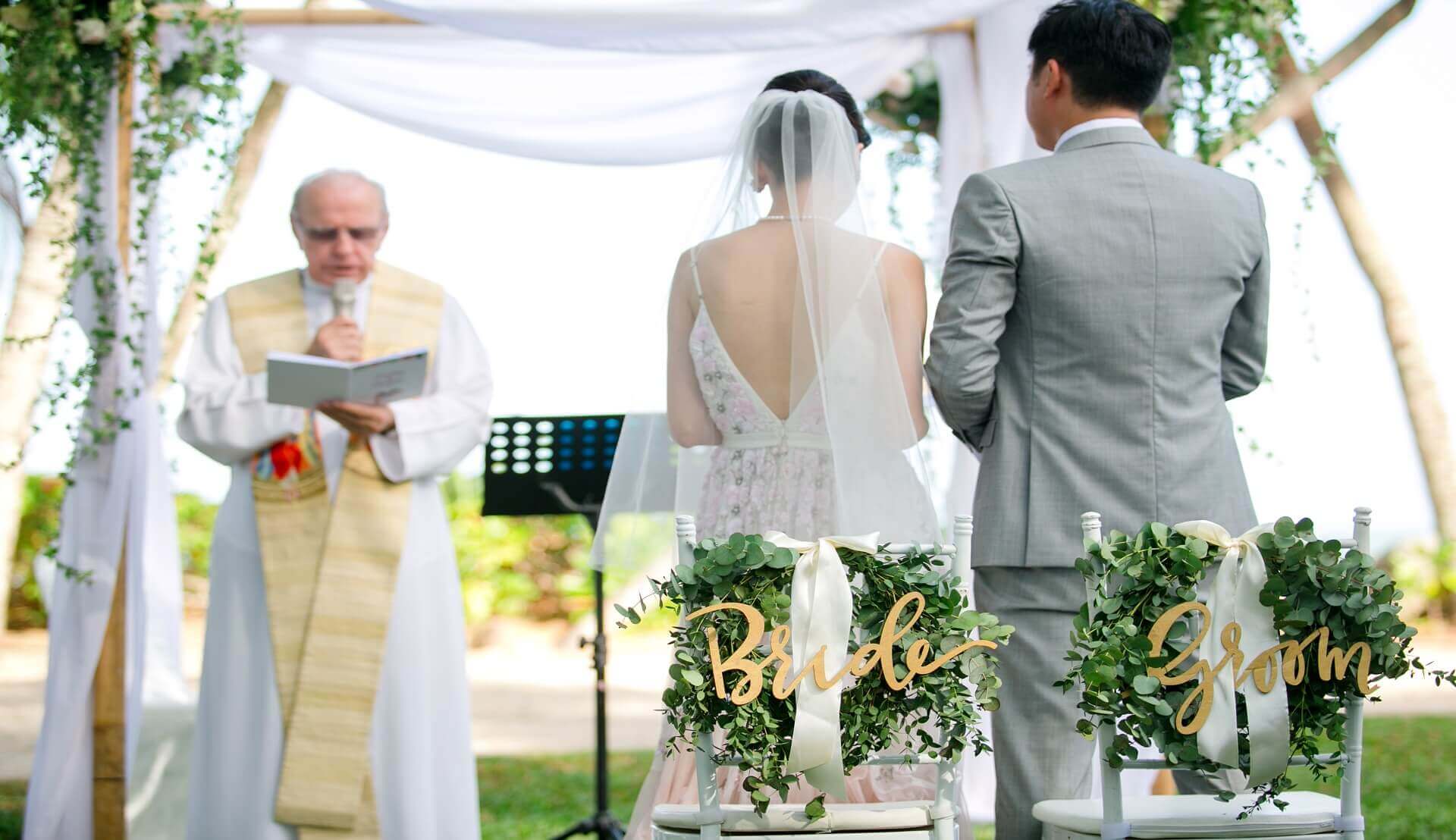Sugar & Spice Events - Bride and groom exchange vow at garden by the beach wedding ceremony at Rasa Sayang Resort
