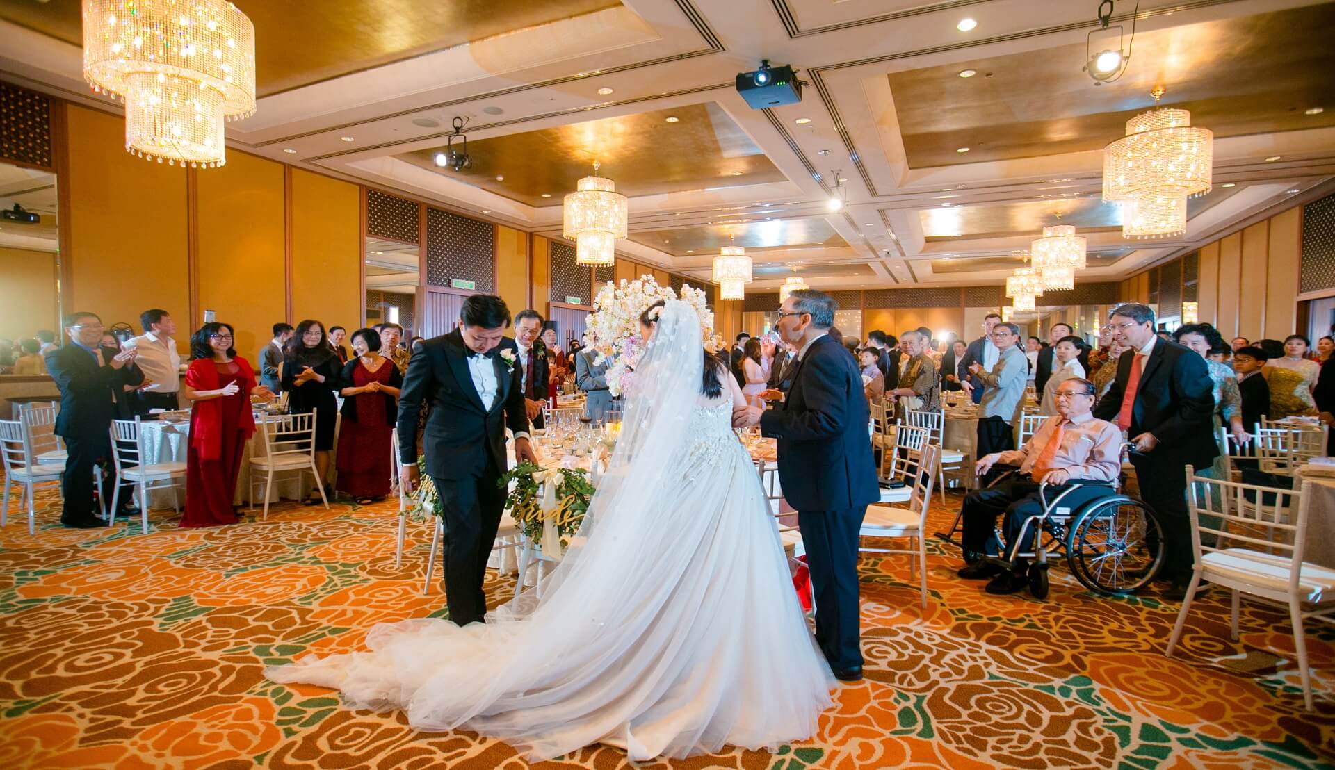 Sugar & Spice Events - Bride, groom, Bridemaids and bestmen posing for the photo in their coat and dresses with flower bouquet in their hand