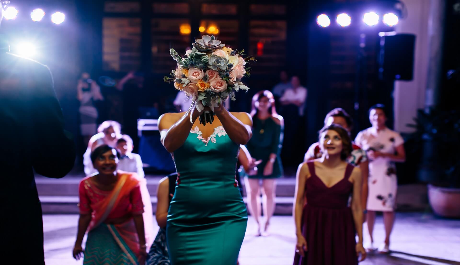 Sugar & Spice Events - Wedding tradition, bride throwing our bouquet toss at Blue Mansion