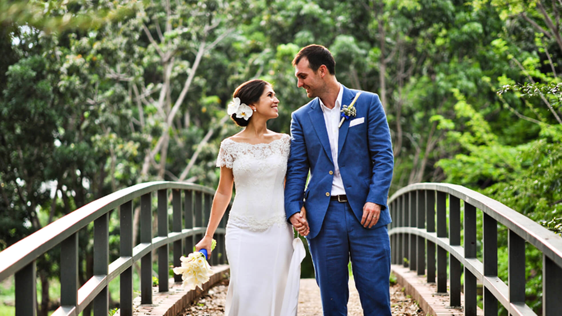 Sugar & Spice Events - Newlyweds walking on a bridge at Suffolk House Penang