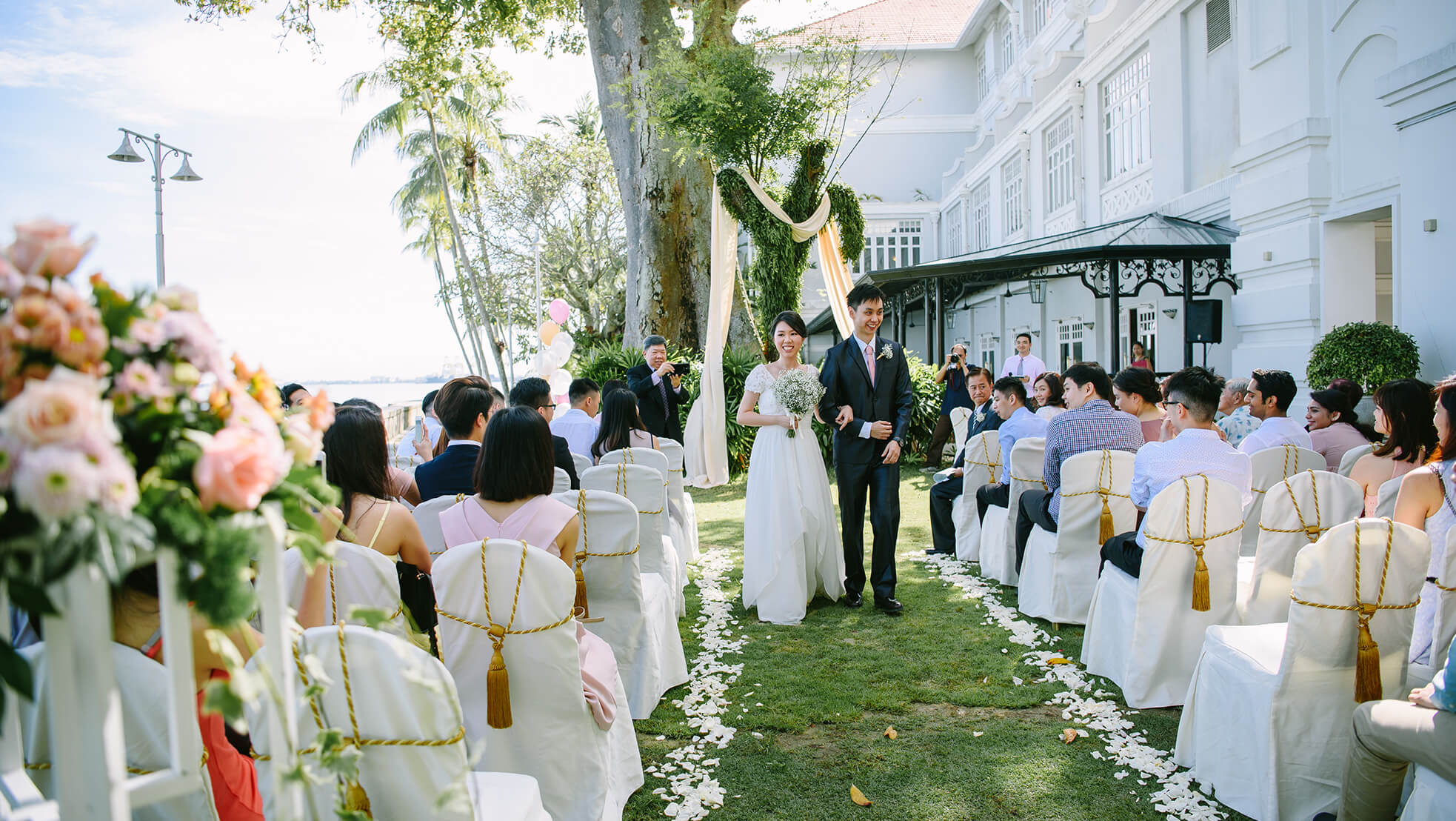 Sugar & Spice Events - Newlyweds walking down the isle just after exchanging vows at the E&O Hotel